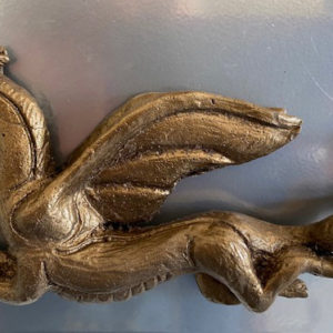 Small relief sculpture of bronze-like dragon by Yvonne Desrosiers